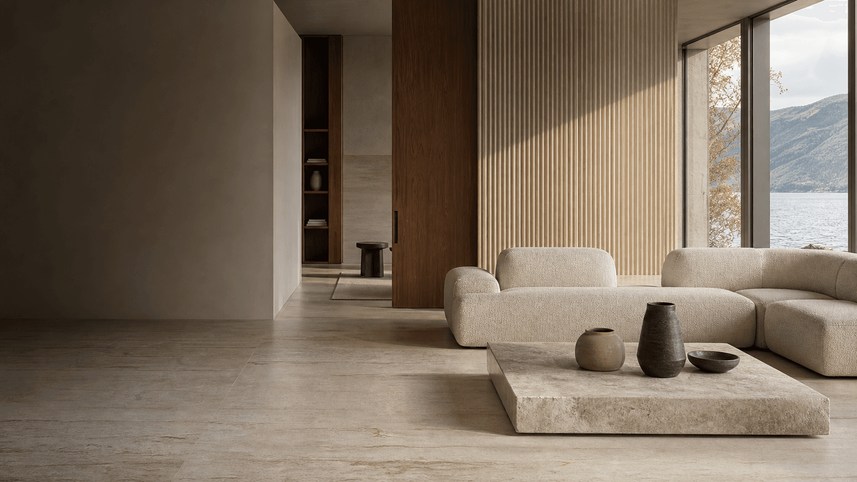 Contemporary living room finished in warm travertine porcelain, ribbed ceramic, and walnut